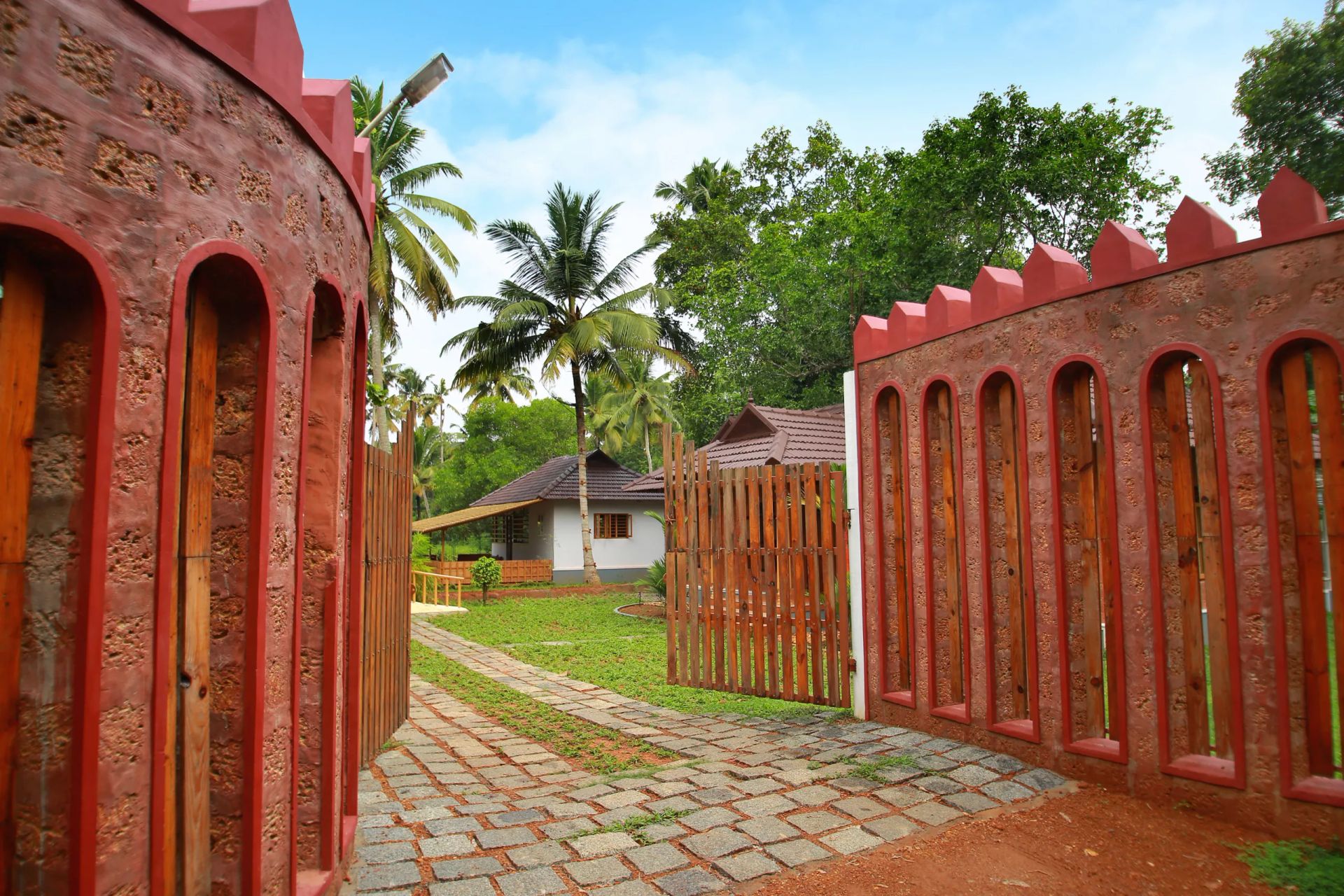 Laterite stone gateway and paved path leading into Casa Marari