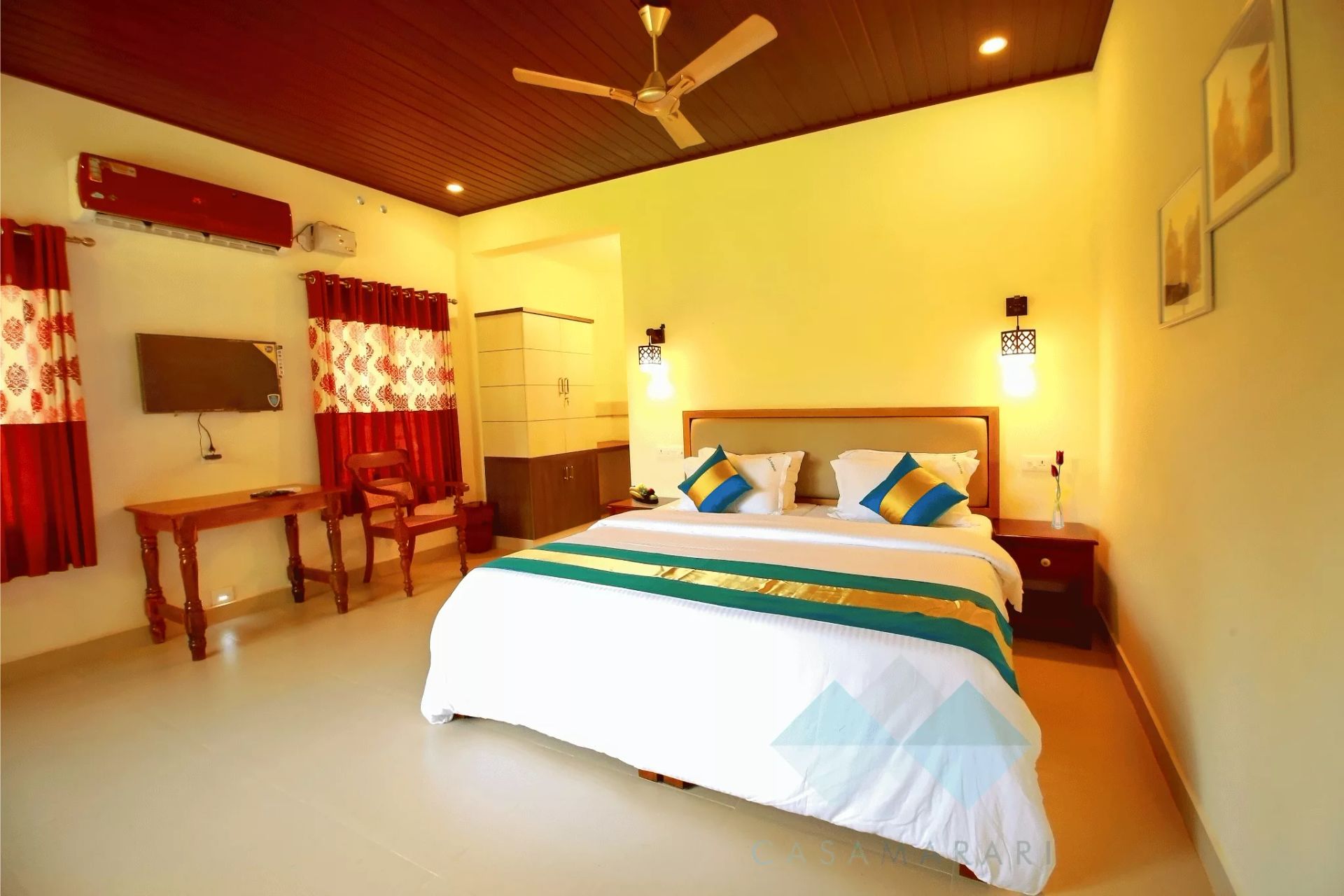 Bright Deluxe AC room at Casa Marari with wooden ceiling and double bed