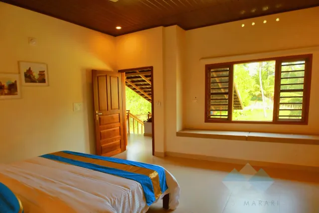 Window seat in a first-floor Deluxe room looking out over coconut palms