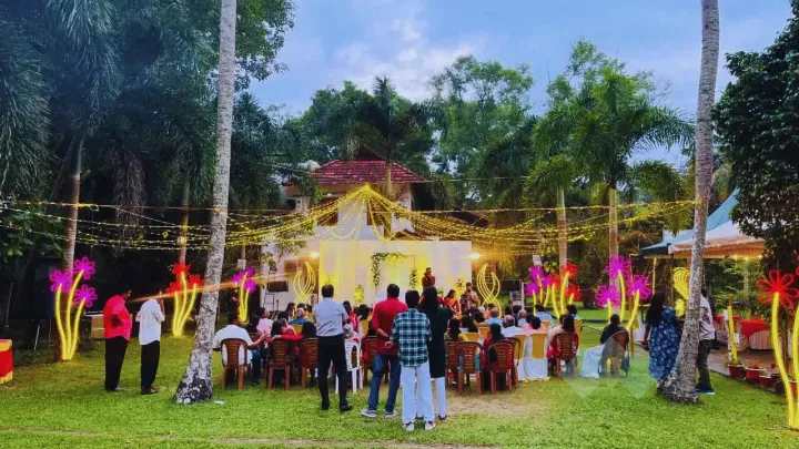 Garden party on the Casa Marari lawn with fairy lights and guests