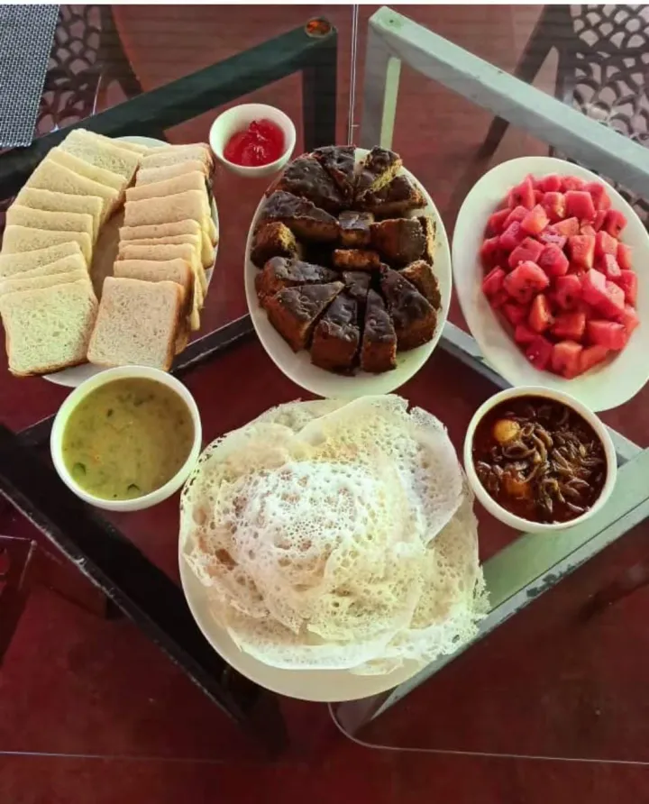 Kerala breakfast spread with appam, curry and fresh fruit at Casa Marari