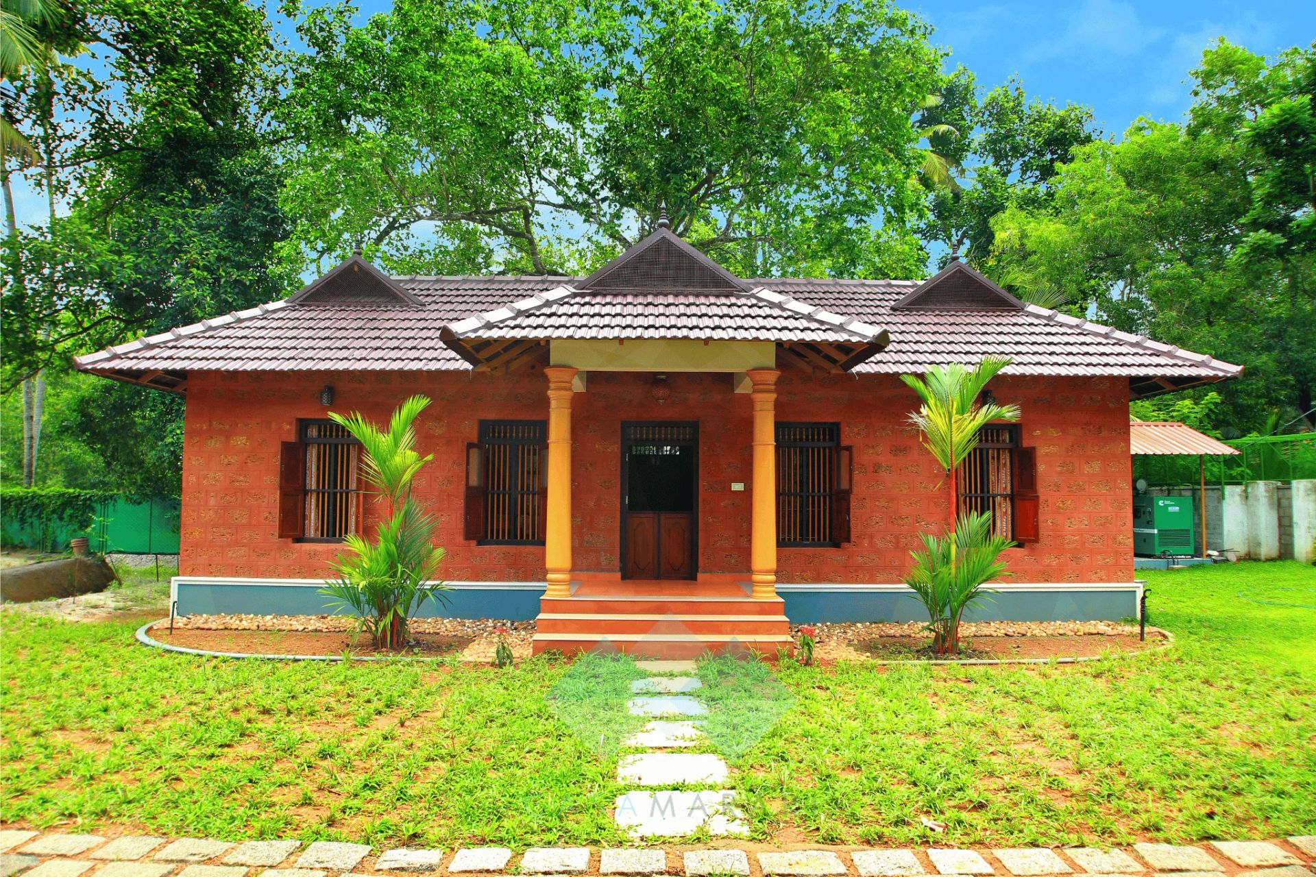 Non-AC villa at Casa Marari — a red laterite Kerala cottage with tiled roof and lawn