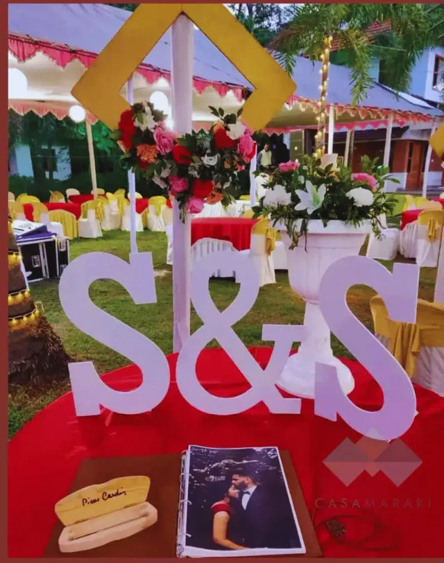 Reception table with floral centrepieces and initials decor