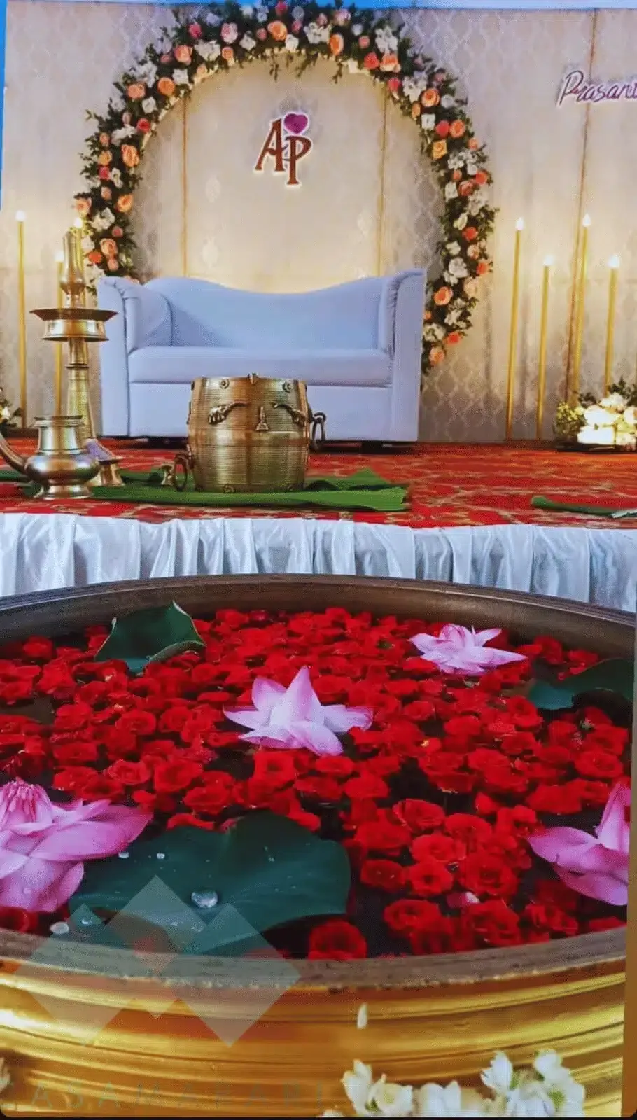 Traditional wedding stage with brass urli and floating flowers at Casa Marari